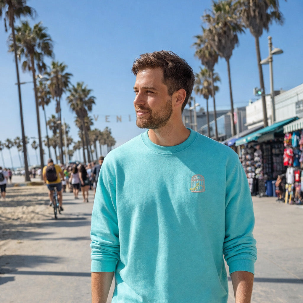 Mens Pool sweatshirt with embroidered chest logo worn on beach boardwalk – Sauce & Brown Pool Sweatshirt lifestyle